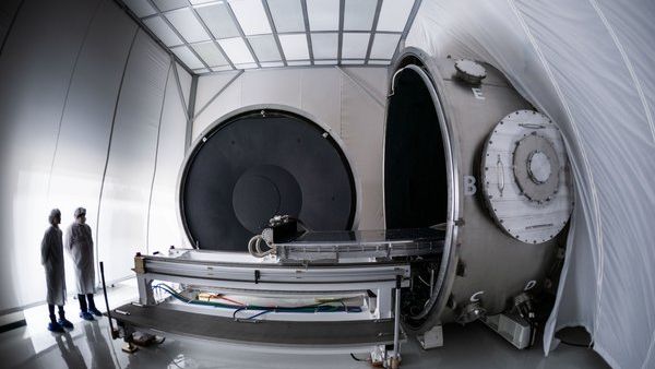 SDL employees with the Thermal & Optical Research (THOR) chamber in a cleanroom.