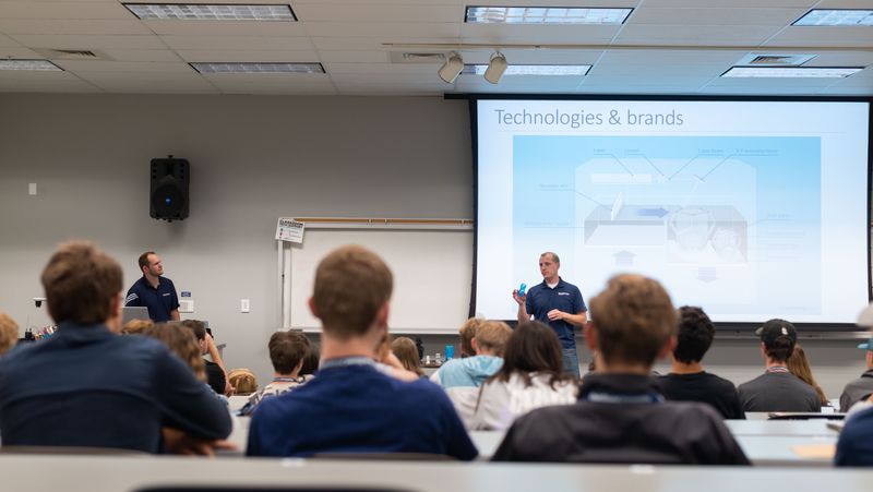 SDL experts give an in-person lecture to a classroom of university students.