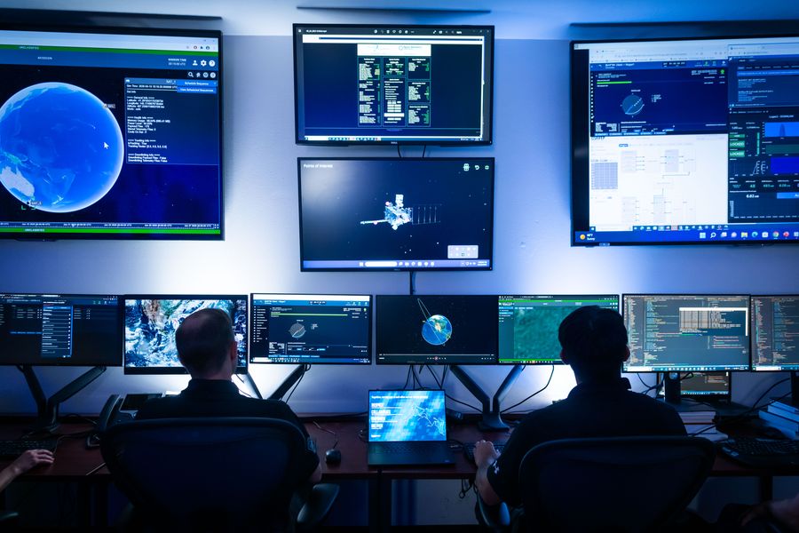 Mission operators transmit and receive data in a mission operations center.