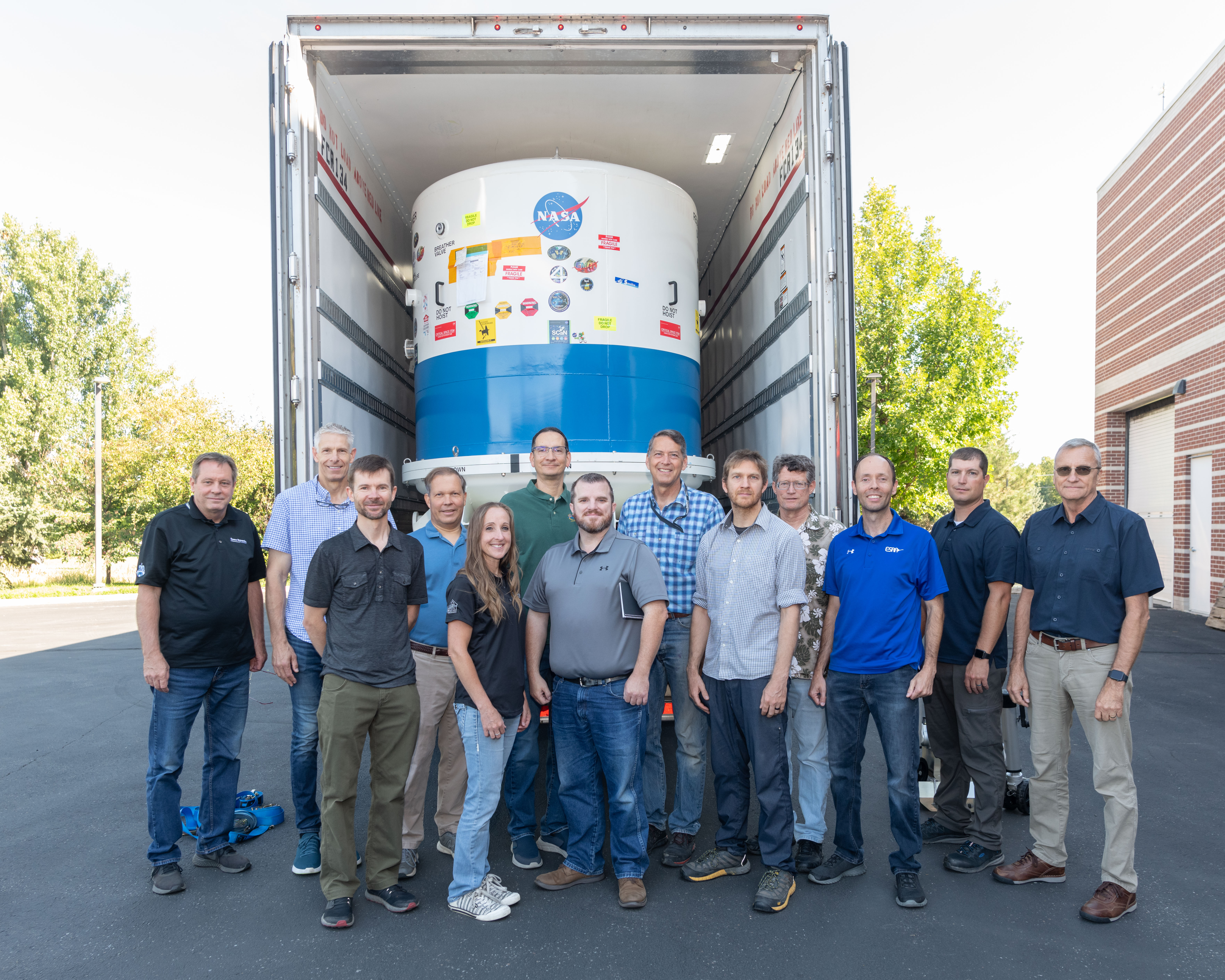 SDL personnel assist with the AWE mission payload shipping operation.