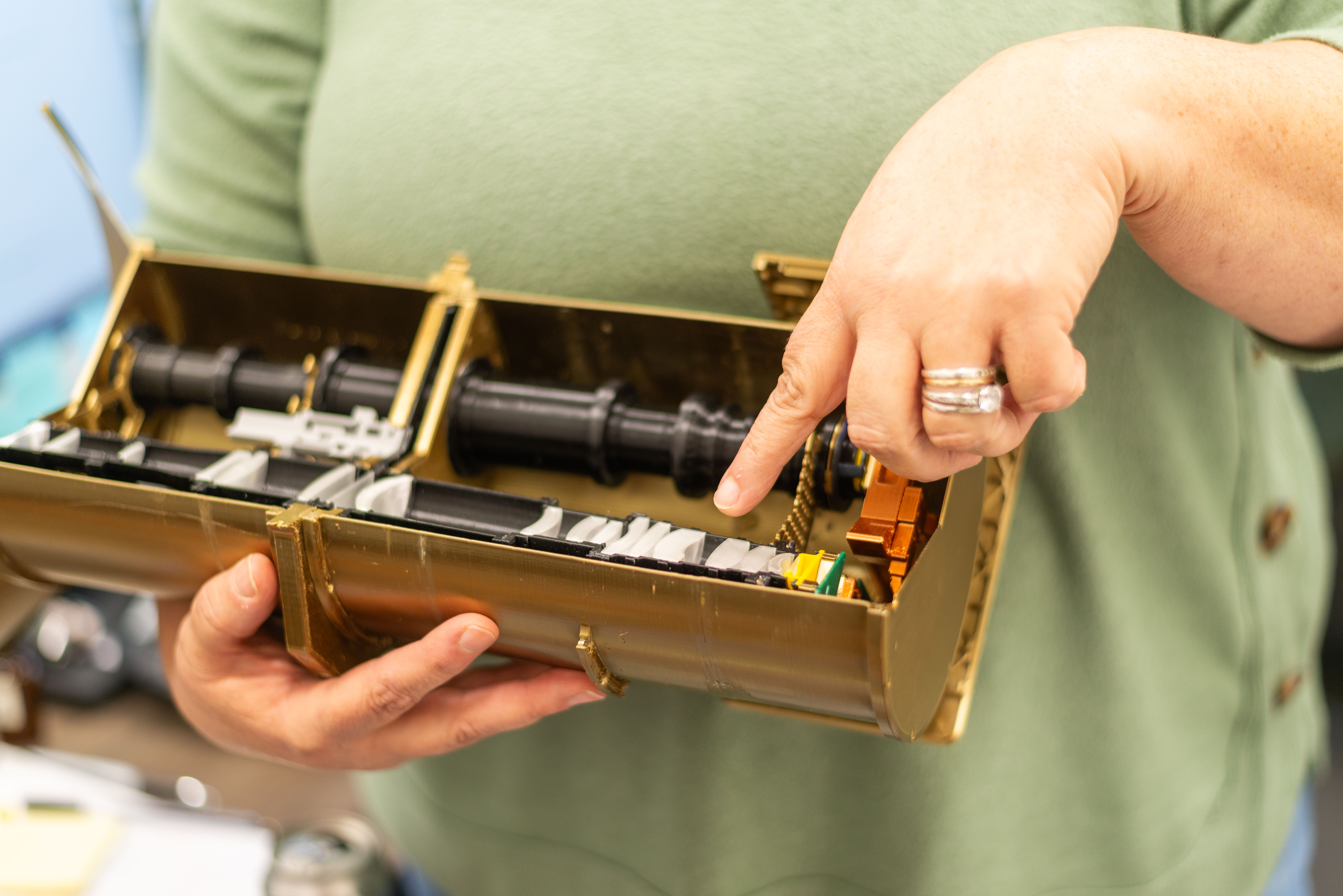 Sherri pointing to the lenses inside of the AWE instrument.